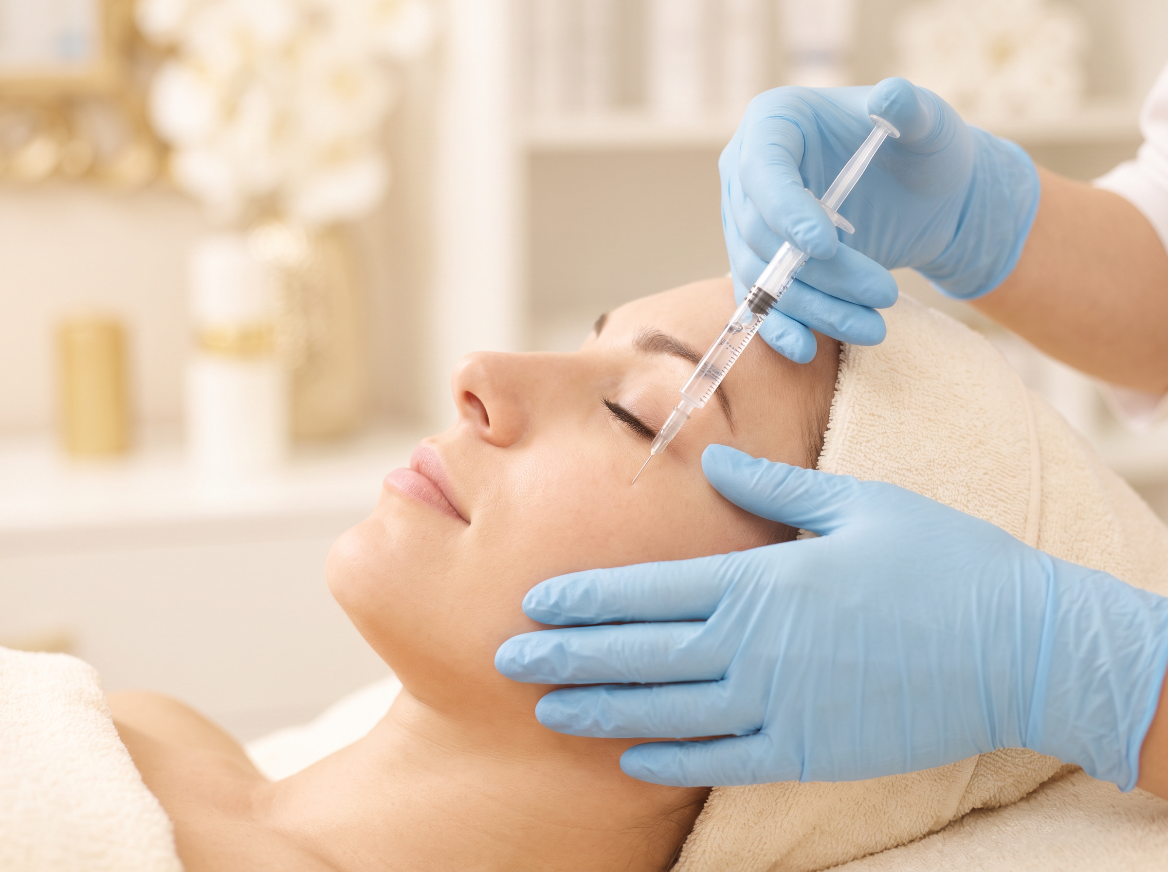 Aesthetic provider holding a fine syringe of clear JUVEDERM filler during a treatment at Houston Wellness & Aesthetics